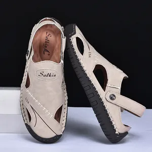 Close-up view of men's beige leather two-way outdoor sandals with Salkin branding