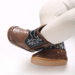 Détail de bottes de cowboy marron pour bébé avec broderie pour l'automne et l'hiver