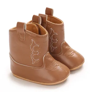 Detailed view of soft brown PU leather infant cowboy boots with white embroidery