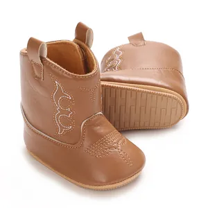 Close-up of brown baby PU leather cowboy boots with anti-slip sole and embroidery