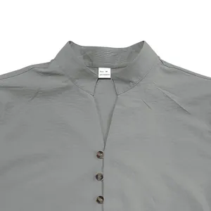 Detailed macro shot showing the stand collar and button neckline of a grey men's shirt