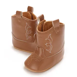 Detailed view of brown PU leather baby cowboy boots featuring white decorative stitching.