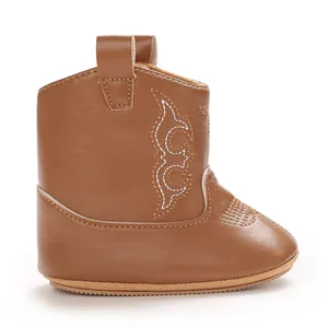 Detailed side view of brown soft PU leather baby cowboy boot with white embroidery.