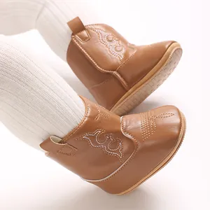 Detail view of stylish brown PU leather baby cowboy boots with anti-slip soles for infants
