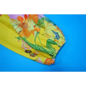 Primo piano della manica di una tuta in lino a fiori con polsino elasticizzato vivace.
