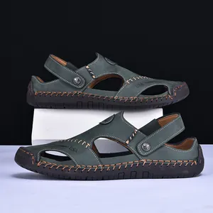 Detail view of men's dark green leather sandals with adjustable heel strap and thick soles.
