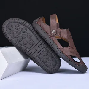 Close-up detail of brown leather men's outdoor casual sandals showing sole and side