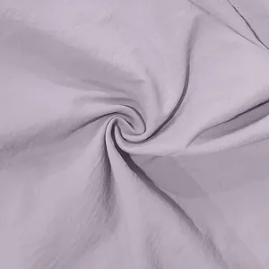 Detailed macro shot of pale purple linen fabric with breathable crinkled texture