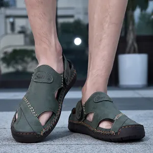 Close-up detail of green leather men's outdoor sandals with hand-stitched seams