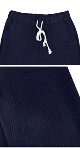 Detailed close-up showing textured navy blue jacquard fabric and drawstring waistband