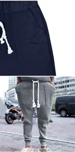Detailed view of men's cable knit joggers with adjustable white rope drawstring.