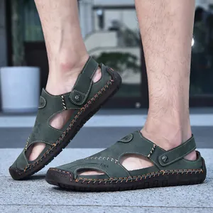 Detailed view of men's olive green leather sandals with decorative hand-stitching.
