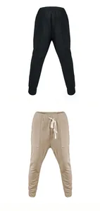 Detail view of men's jacquard casual trousers in black and khaki with drawstring.