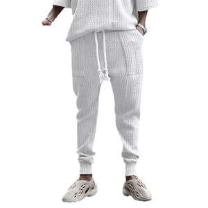 White cable-knit drawstring joggers for men featuring a minimalist streetwear design