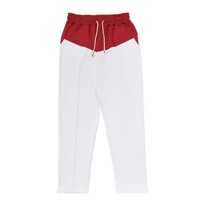 Detail shot of men's red and white color-blocked oversized straight-leg sweatpants