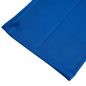 Macro view showing double-stitched hem details of blue casual oversized trousers