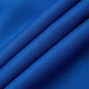 Close-up macro texture view of high quality royal blue fabric for men's casual pants