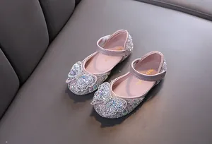 Detailed macro view of pink girls' princess shoes with rhinestones and butterfly bow