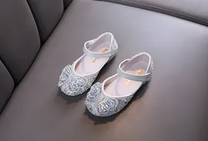 Detailed view of silver girls' princess shoes with sparkling rhinestone butterfly bow