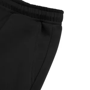 Detailed view of black elastic waistband and side pocket on men's relaxed fit trousers