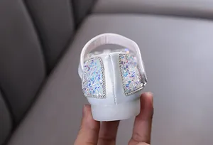 Detailed back view of white girls princess shoes with iridescent sequins and crystals