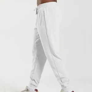 Side view of white men's jogger pants featuring drawstring waist and elastic cuffs.