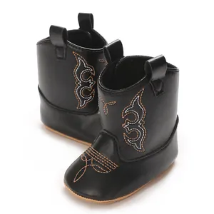 Detailed view of black baby cowboy boots with western style embroidery patterns