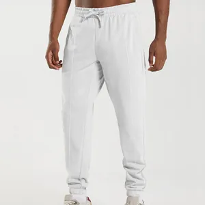 Detailed macro view of white drawstring jogger sweatpants with elastic cuffs for men