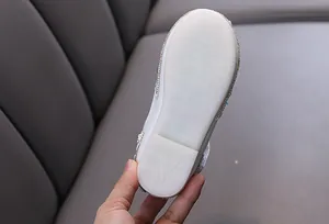 Close-up view of white anti-slip outsole on girls' rhinestone princess shoes