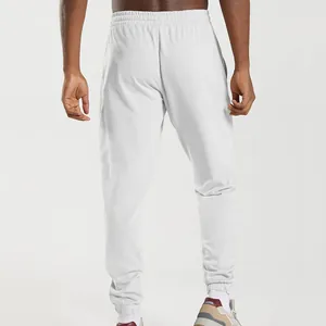 Back view of men's white casual joggers featuring an elastic waistband and ribbed cuffs.