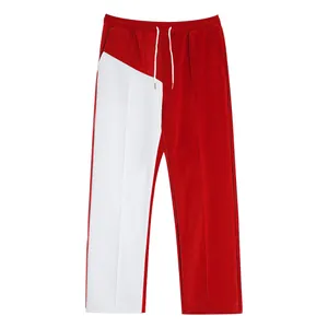 Front view of men's color-blocked trousers featuring bold red and white fabric panels