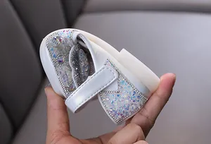 Detailed view of white girls' princess dress shoes with sparkly iridescent rhinestone accents