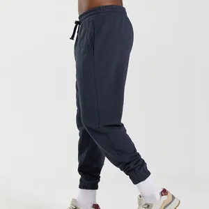 Side view of men's navy blue joggers showing the relaxed fit and elastic cuffs.