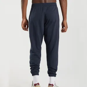 Rear view of men's loose navy knit sweatpants with cuffed ankles for casual sports