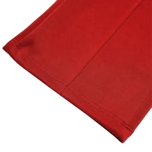 Macro view showing the double-stitched cuff and fabric texture of red casual pants