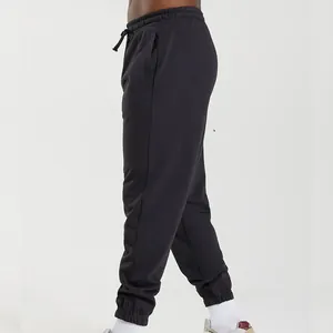 Side view of black men's joggers with elasticated cuffs and a drawstring waist.