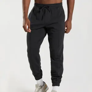 Close-up of men's black joggers showing drawstring waist and knit fabric texture