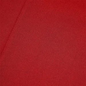 Macro detail of red men's trousers fabric showing fine knit texture and durable seam.