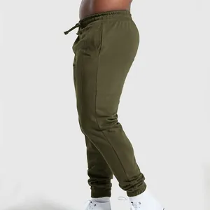 Detailed side view of men's olive green knit joggers with drawstring and cuffed ankles