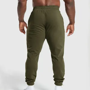 Back view of men's olive green loose joggers featuring elastic waist and cuffs