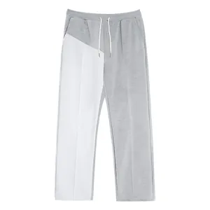 Detail of men's gray and white patchwork casual straight-leg pants with drawstrings.