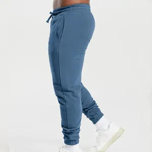 Side view detail of comfortable blue men's joggers featuring drawstring and ribbed cuffs