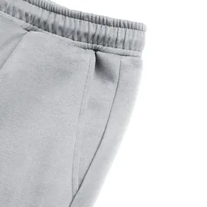 Detailed close-up of elastic waistband and side pocket on gray men's casual sweatpants