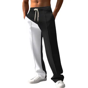 Men's loose color-block pants featuring black and white contrast stitching design