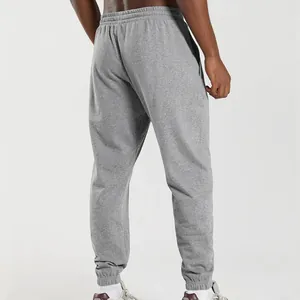 Rear view detail of men's gray joggers showing elastic waistband and cuffed ankles