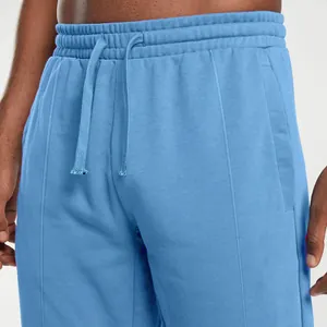 Detailed view of light blue men's knitted sweatpants with adjustable drawstring waistband