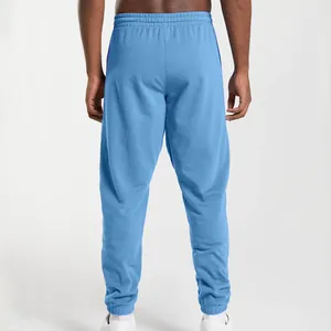 Back view of men's loose light blue joggers with cuffed ankles for casual sports wear