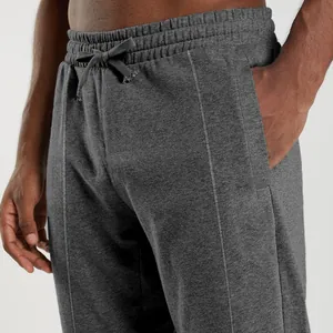 Close-up detail of dark gray knit joggers featuring drawstring waistband and side pocket