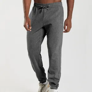 Close-up of men's dark grey jogger sweatpants with pintuck detail and drawstring waist