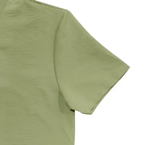 Close-up of sage green vintage linen shirt sleeve showing textured fabric